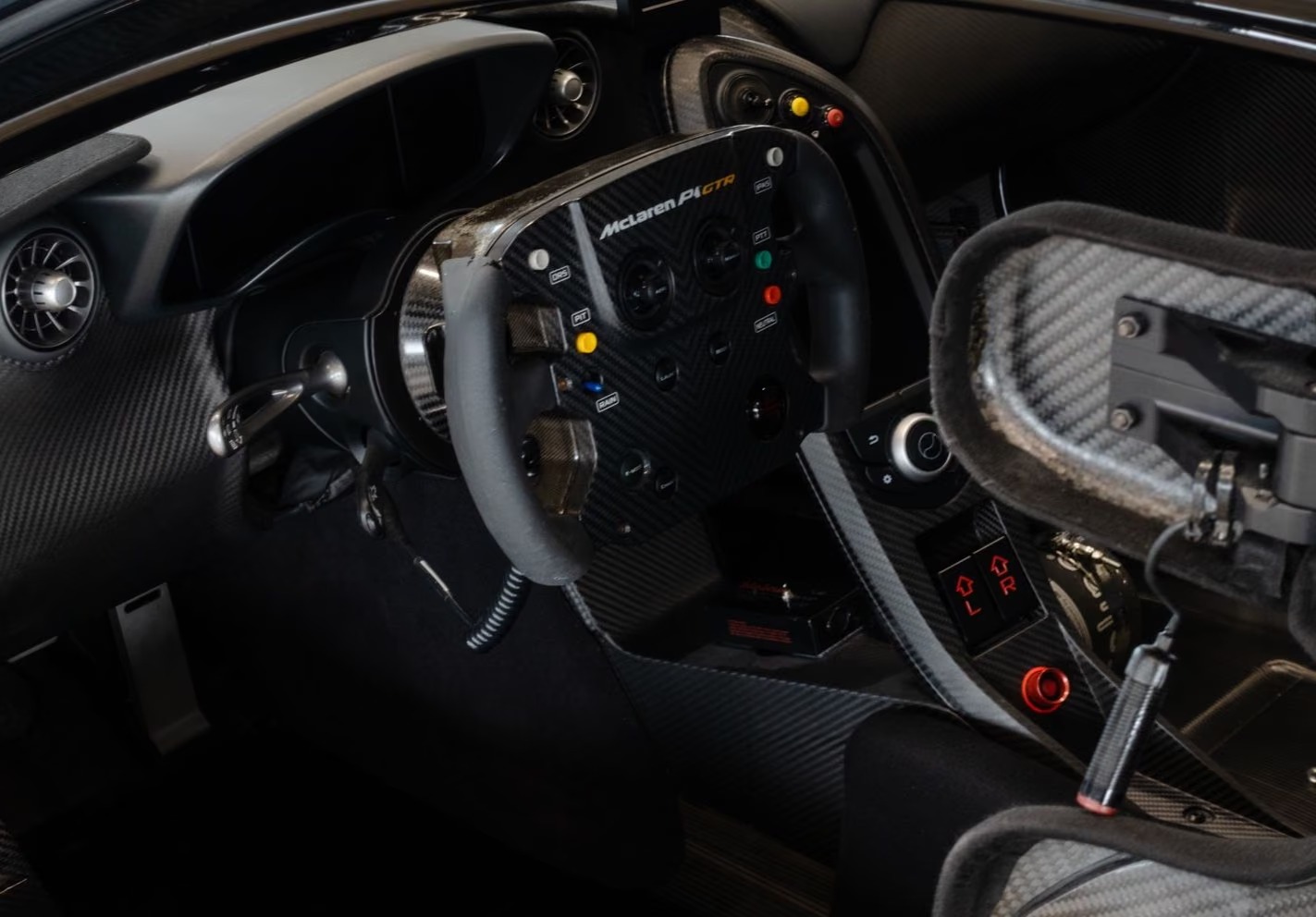 Driver's view of the McLaren P1 GTR cockpit with carbon fibre trim and race switchgear.