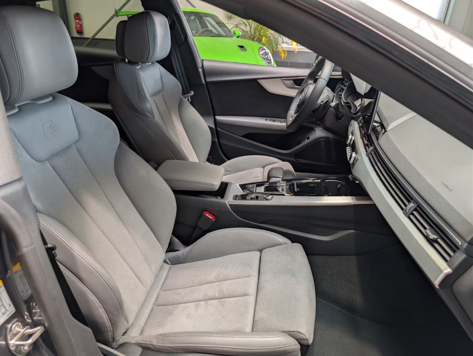 Passenger-side interior of the Audi A5 Sportback showing the front sport seats, centre armrest and dashboard trim.