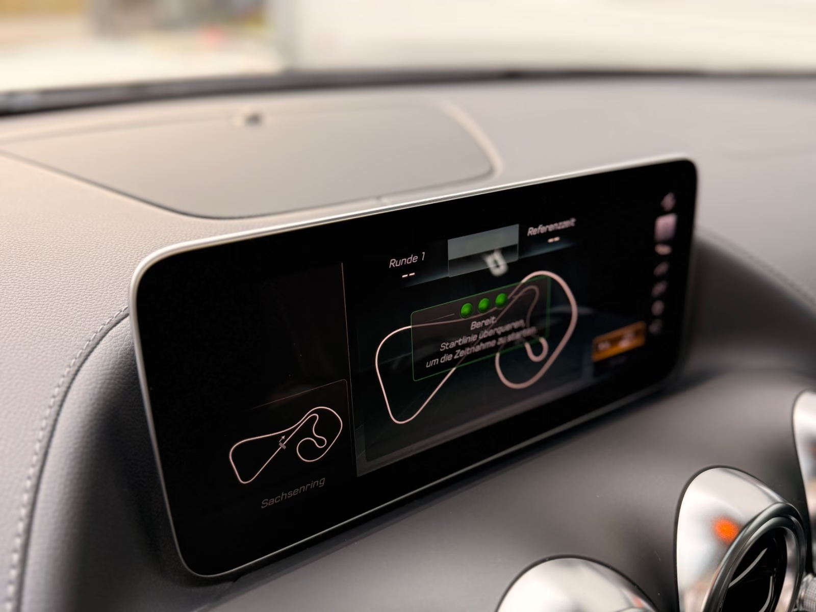 Central display of the Mercedes-AMG GT C showing the AMG Track Pace lap timing screen.