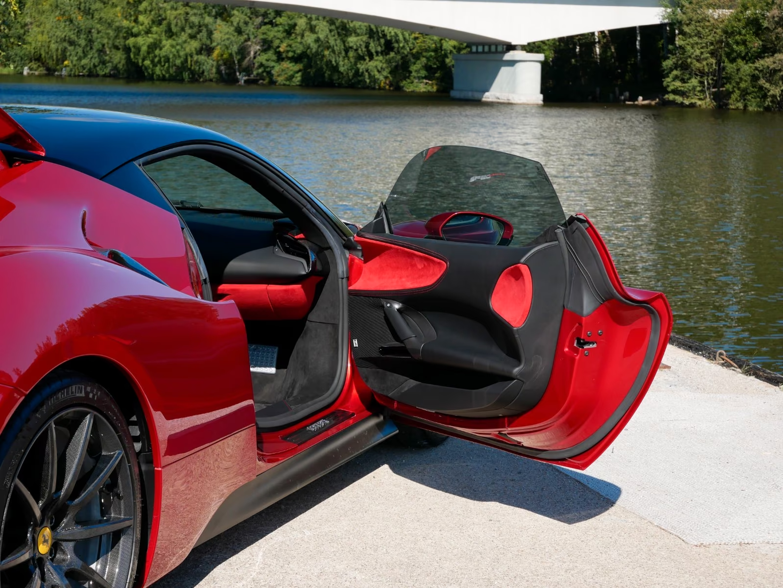 Ferrari SF90 Stradale 2022 — open door with carbon and red Alcantara trim