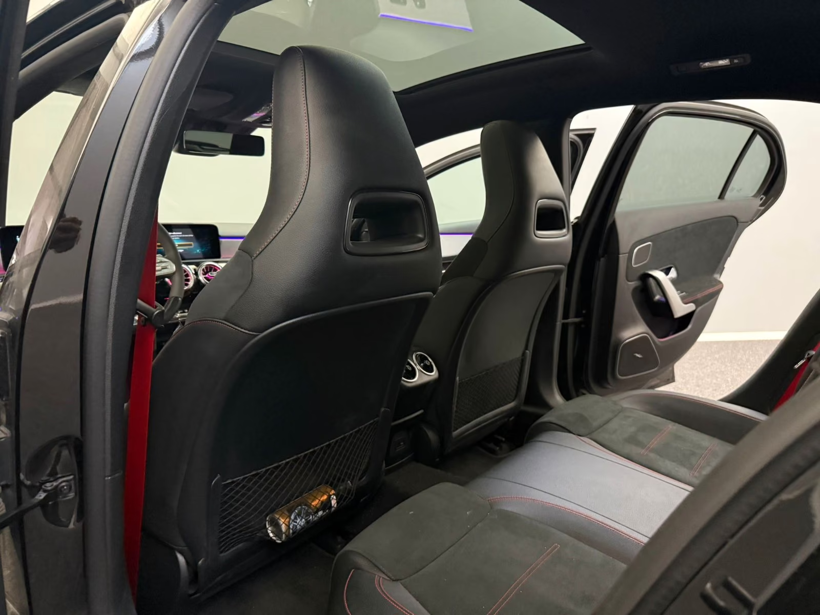 Mercedes-AMG A 35 4MATIC 2021 — rear seats in black Alcantara with red seat belts