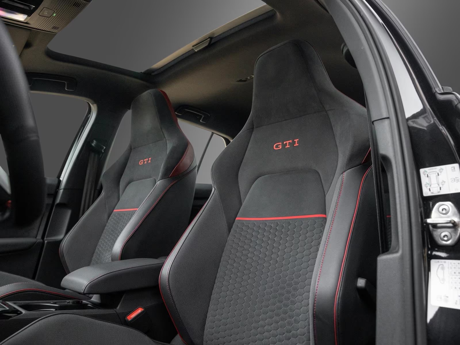 Alcantara top sport front seats with GTI embroidery and red piping.
