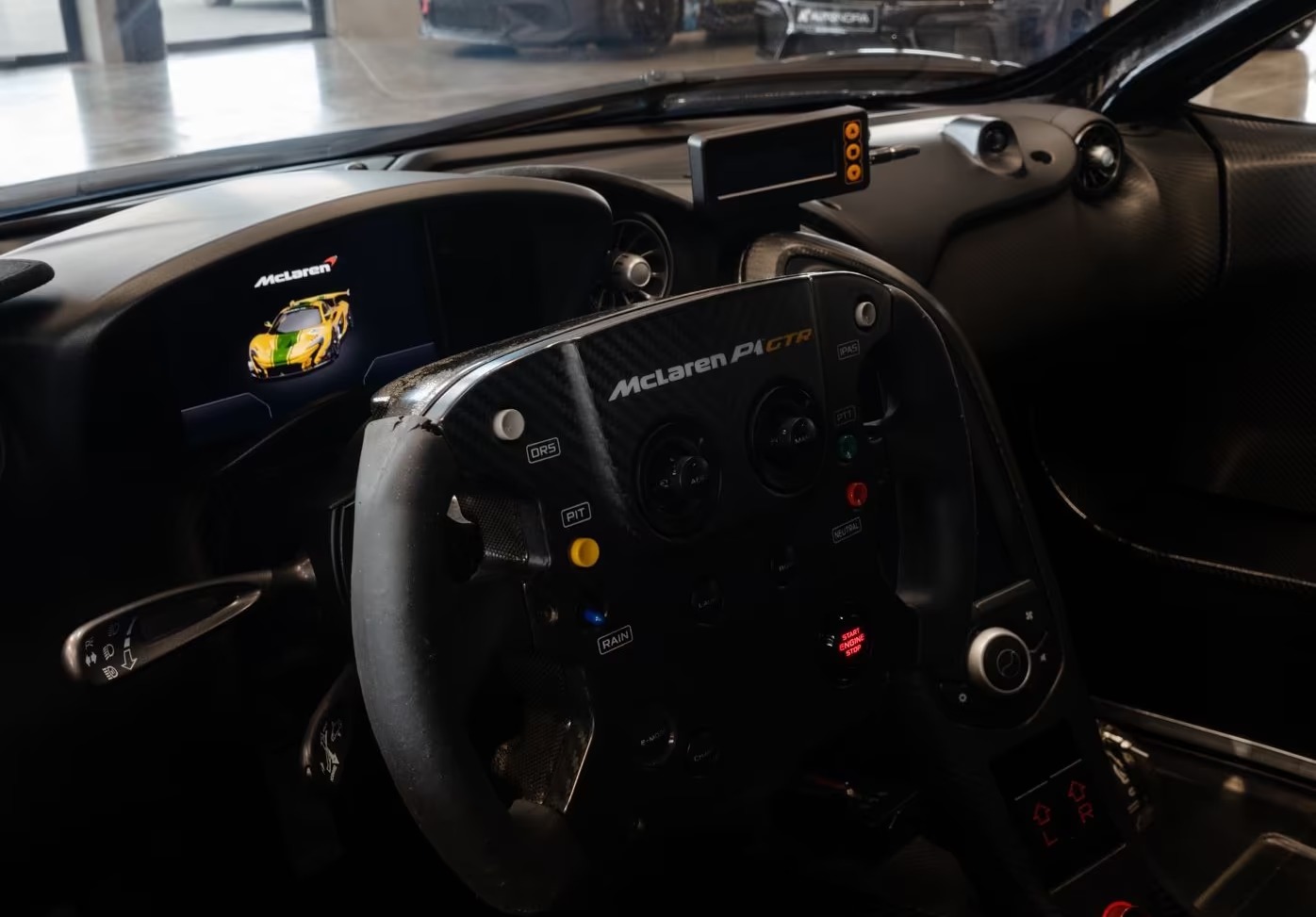 Close-up of the McLaren P1 GTR steering wheel with DRS, pit and rain controls.