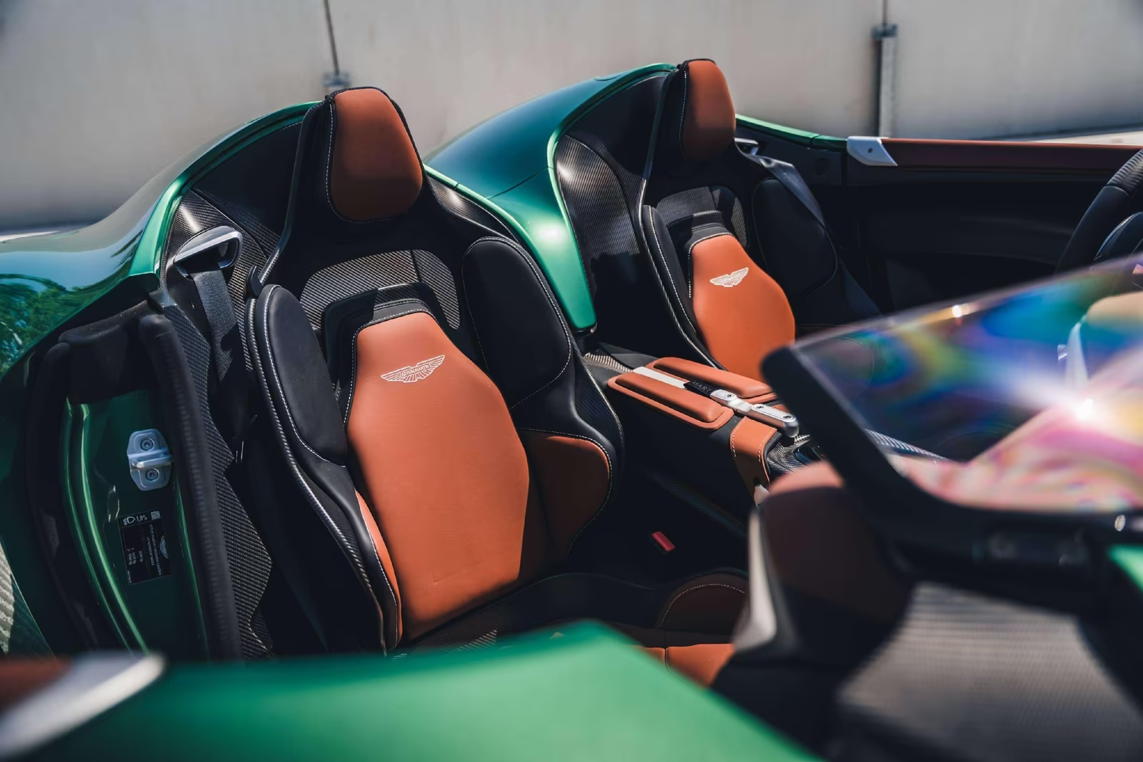 Both DBR22 seats in Chestnut Tan leather with embroidered Aston Martin wings and carbon shells.