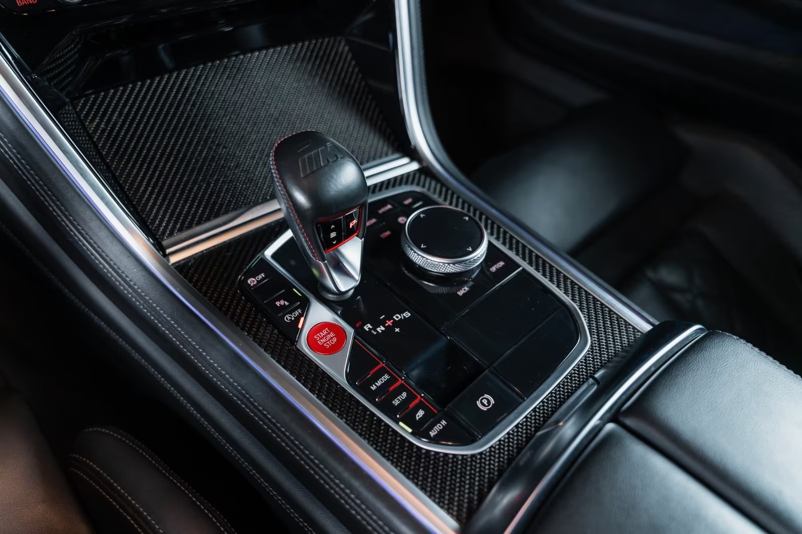 Carbon centre console of the BMW M8 with the M gear selector, Start Engine Stop button and M Mode controls.