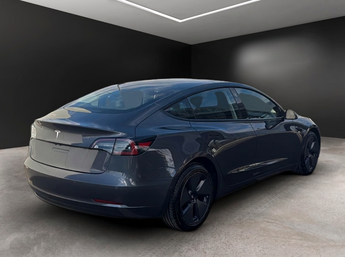 Rear three-quarter view of the Tesla Model 3 on 18-inch alloy wheels.