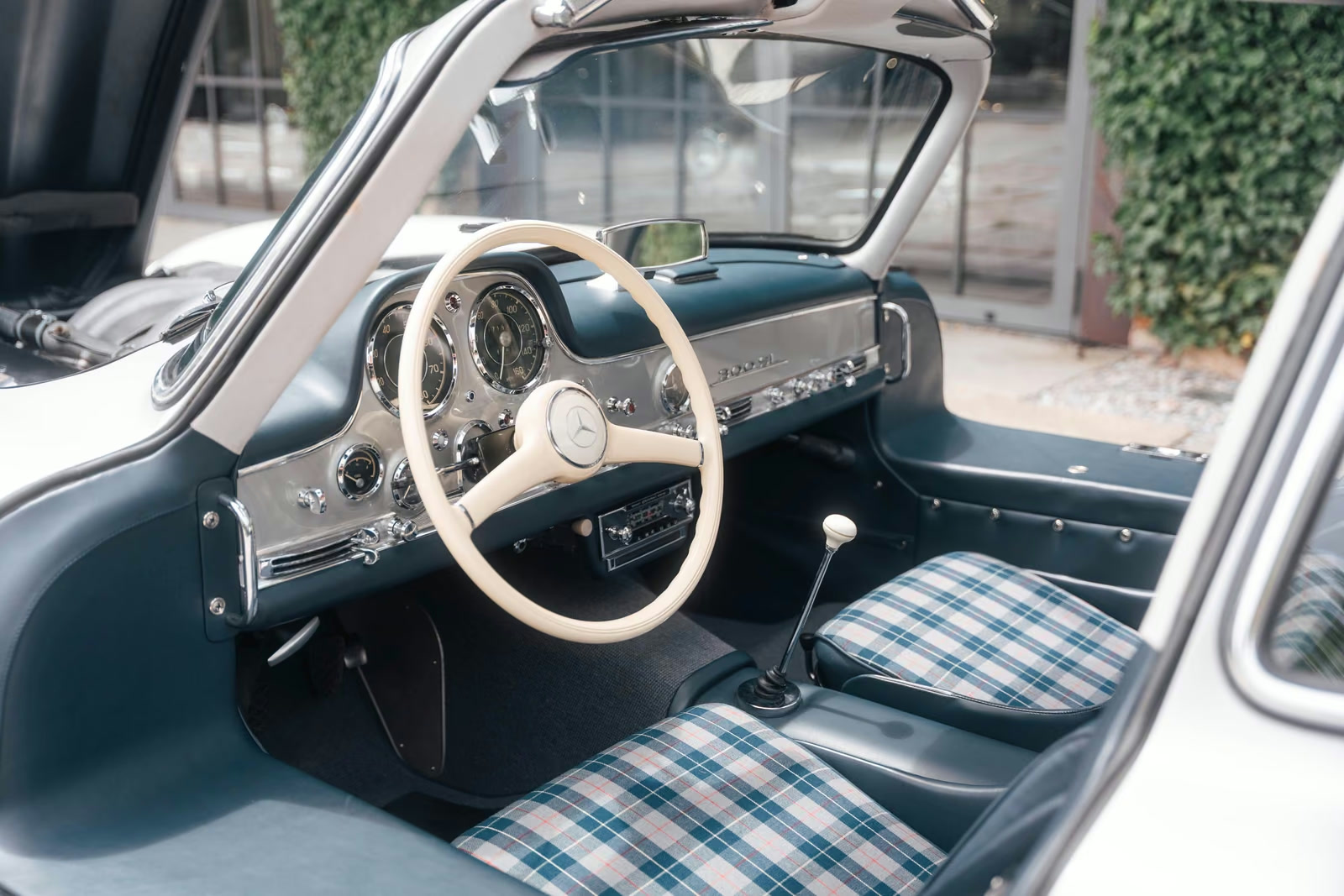 Blue 300 SL dashboard, cream steering wheel and plaid front seats